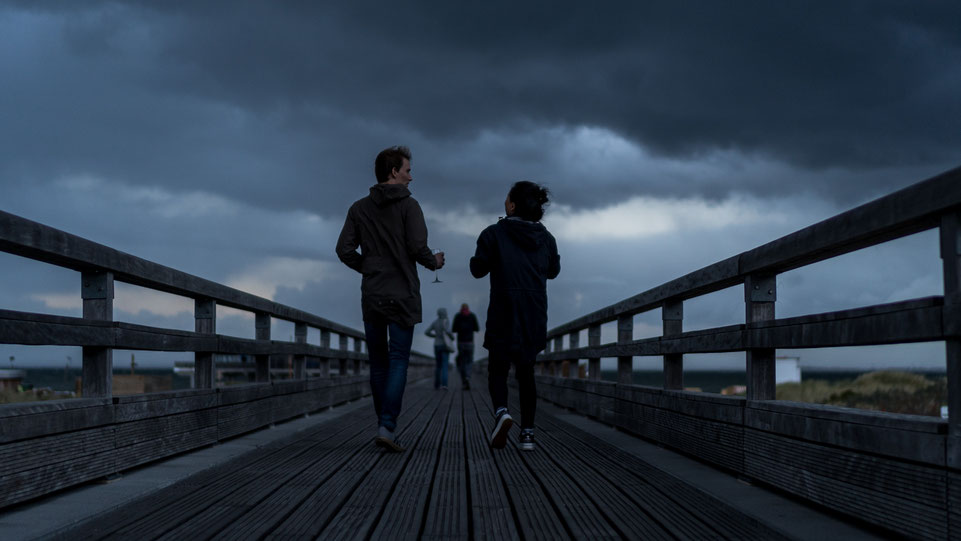 Two couples walking Seebrücke Heiligenhafen