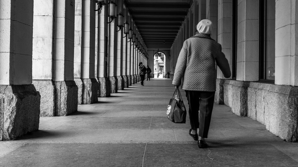 A lady walking down an archway in Wroclaw