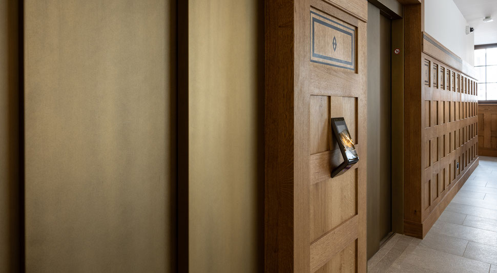 Holzwand der Schreinerei Bever AG hinter der Rezeption im Hotel Grace La Margna St. Moritz