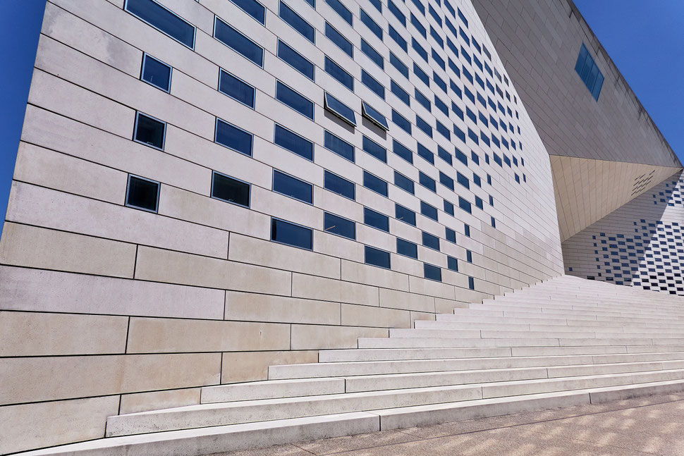 The image shows a photograph of a part of the entrance stairs and facade of the Meca Museum in Bordeaux.
