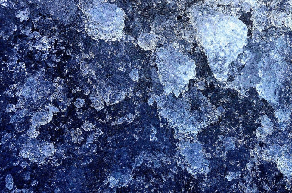 The photograph shows an image of ice crystals in high contrast.