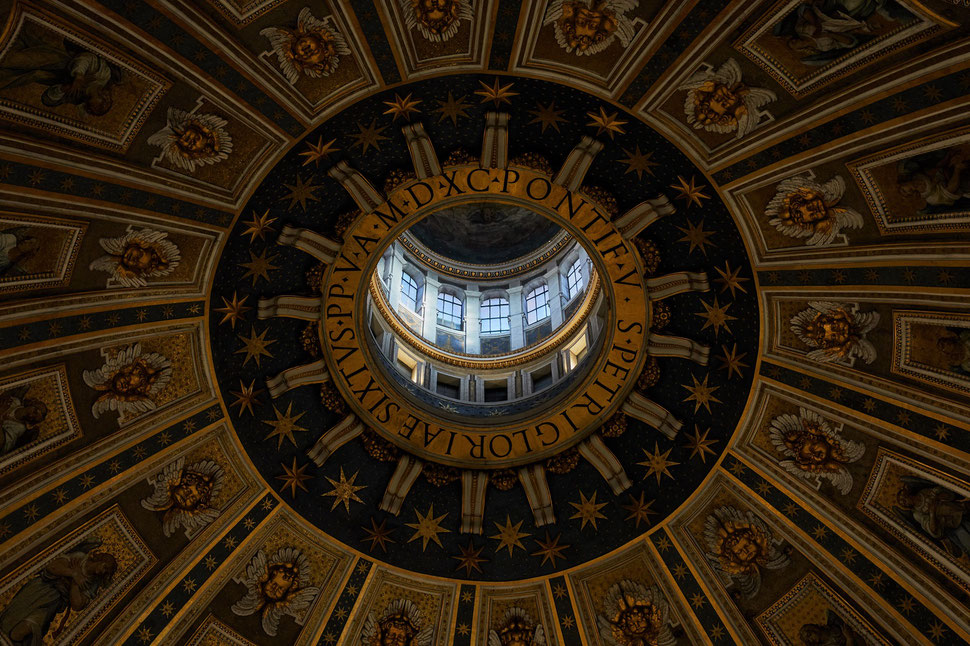 The image shows the photograph of a snippet of the inside of the roof of the Saint Peter's Basilica in Rome.