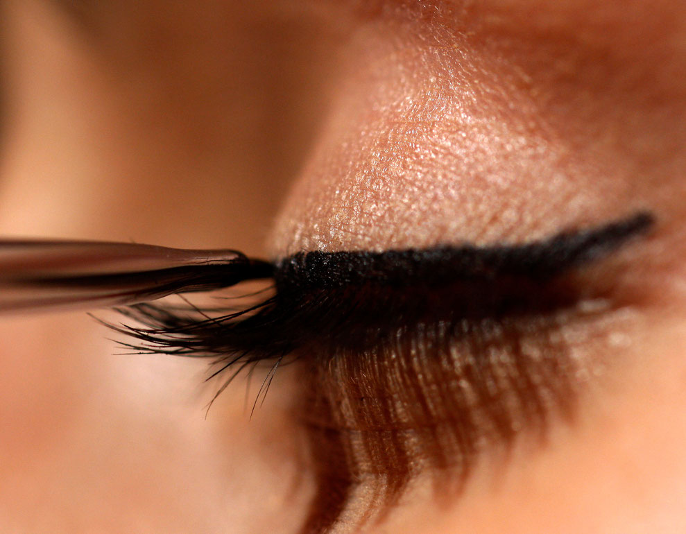 A model has make-up applied to her face  during the Lisbon Fashion show in Cascais March 13, 2009.