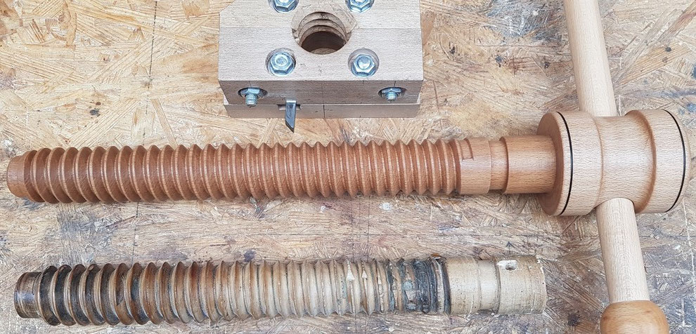 Old and replica wood vise screw side by side.