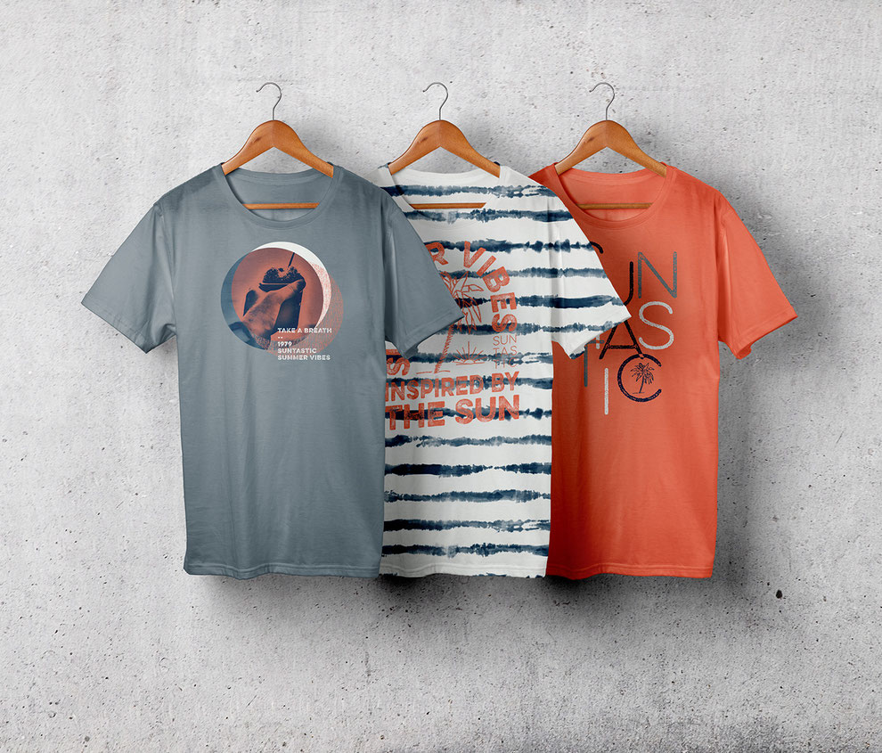 three t-shirts hanging on a wall
