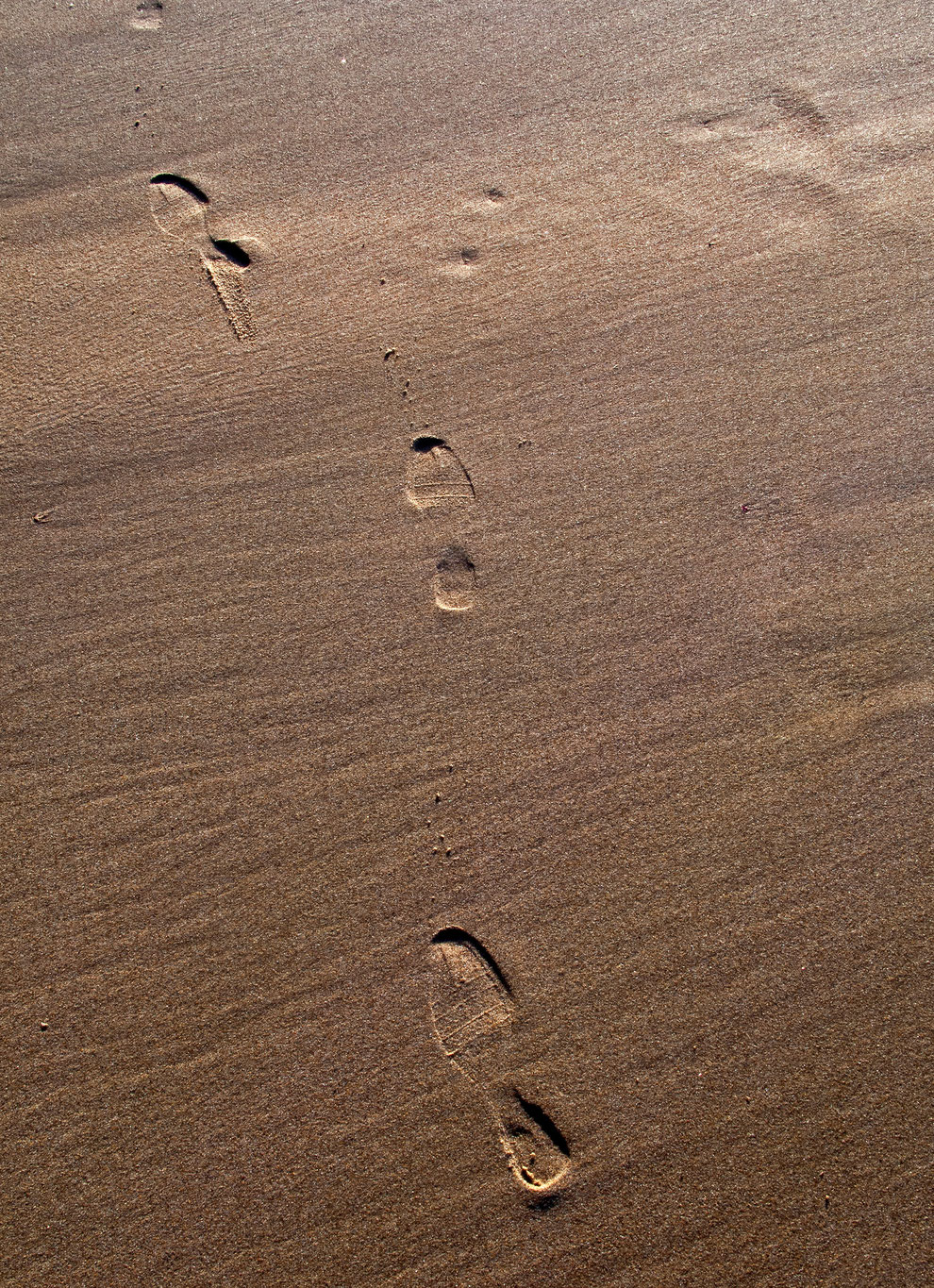 Foot prints on the sand of a beach North of Lisbon on 2019