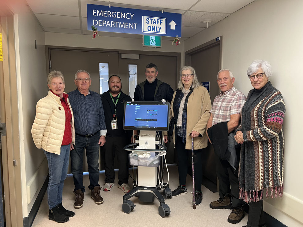 Joanne Easdown, Richie Gage, Mark Bagabuyo, Duncan Ross, Jean Perog, Jerry Sanders and Kathryn Olsen with the new portable ultrasound machine at NVH.