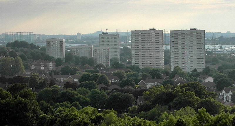 Blocks of flats on Bromford ; low-rise houses among the trees in the foreground are on the Firs estate. In the distance the Dudley hills.