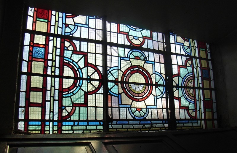 The Victorian glass which filled all of the windows was replaced c1960 with clear glass to let in more light. A little remains on the ground floor of the tower. 