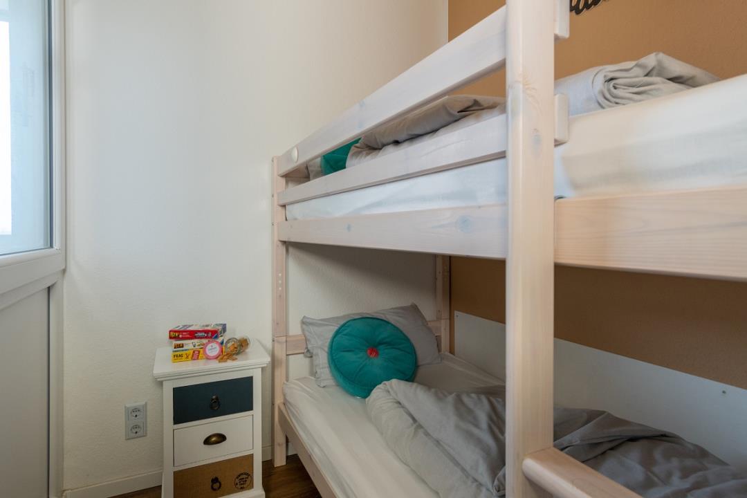 Kinderzimmer mit Etagenbett und großem Fenster mit Blick nach draußen ...