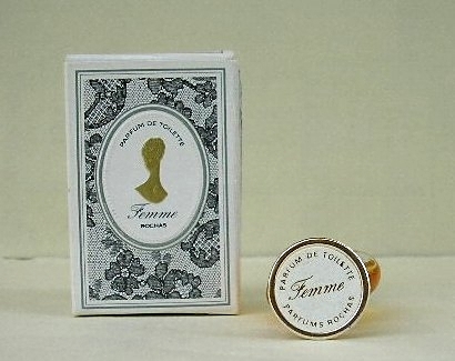 FEMME - PARFUM DE TOILETTE - MINIATURE CI-DESSUS DONT LE BOUCHON PORTE UNE ETIQUETTE BLANCHE