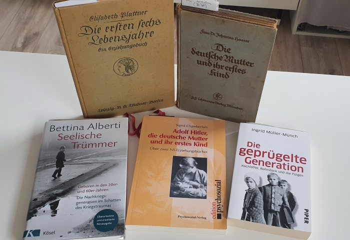 Auf dem Bild sind fünf Bücher auf meinem Küchentisch zu sehen, darunter auch das Buch "Die deutsche Mutter und ihr erstes Kind" von Johanna Haarer. Ein anderes Erziehungsbuch von 1935 ruft ebenfalls zum Gehorsam auf.