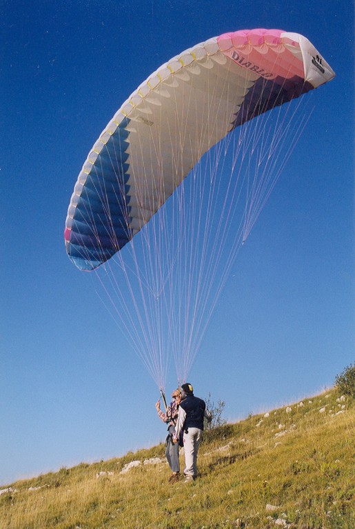 Paragliders and hang-gliders take off from the Buc mountain