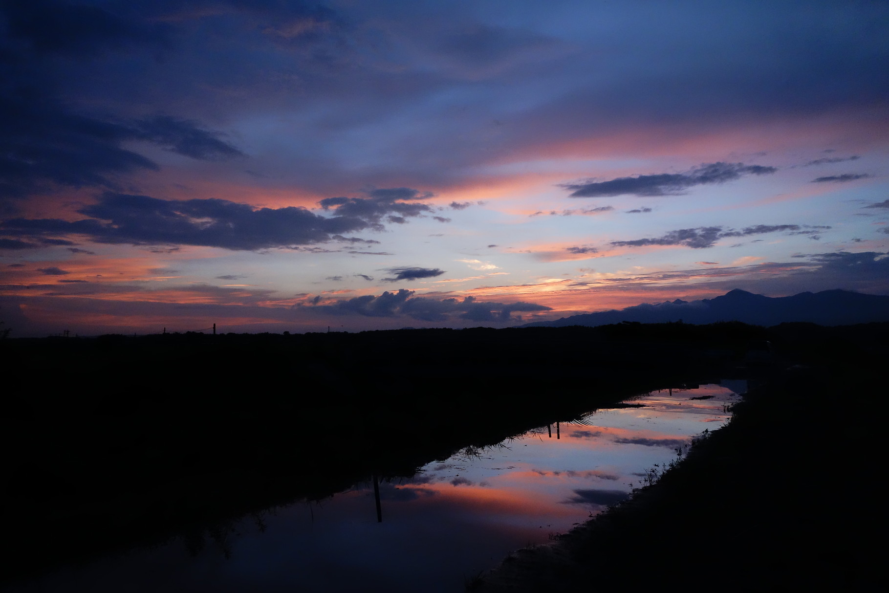 雨上がりの夕景と大きな水たまり。まるで空が２つあるような錯覚を覚える。