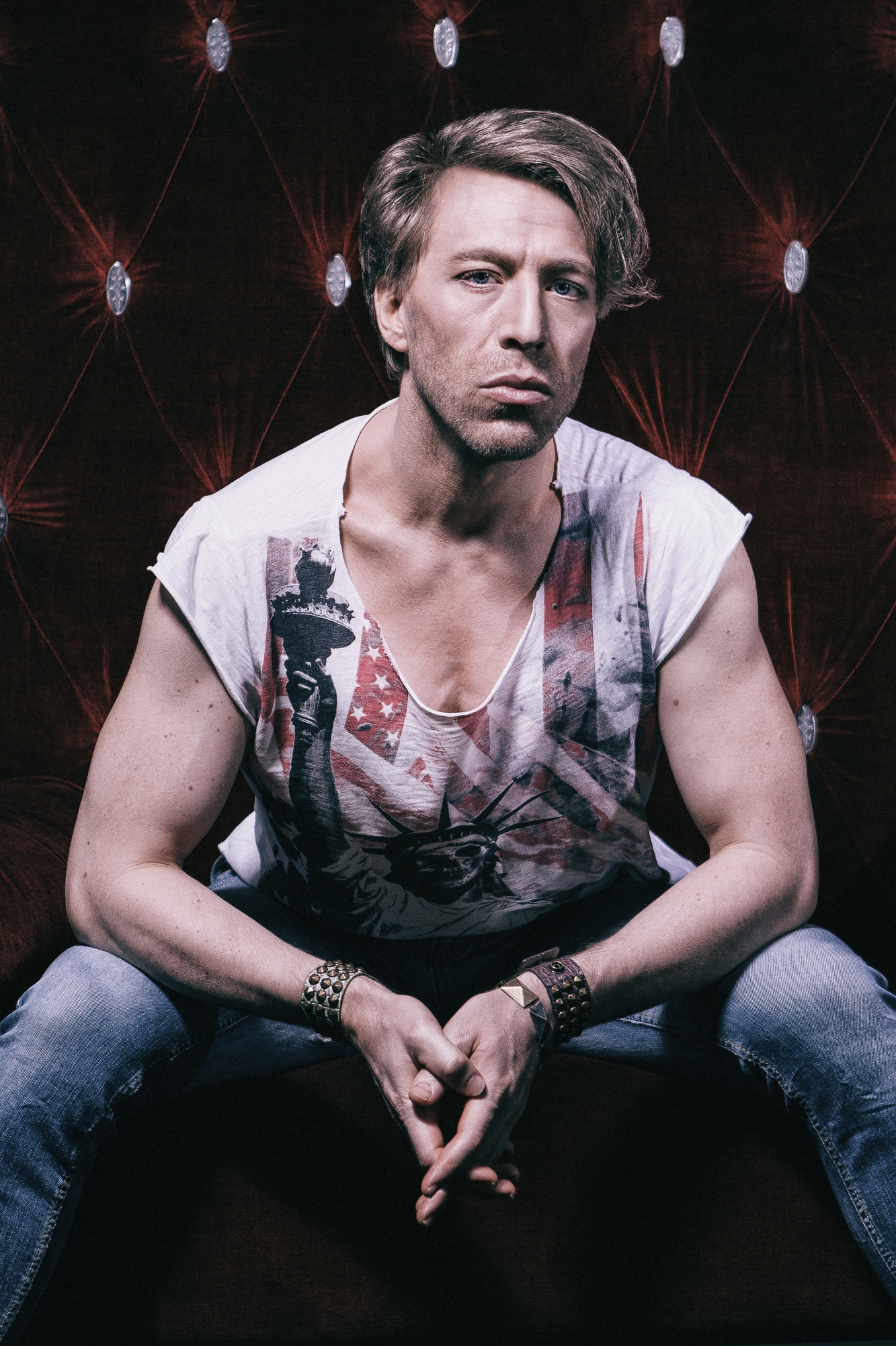Ottaviano Blitch, Italian actor and performer, edgy rock editorial portrait seated in a printed tank top, attore performer italiano ritratto rock editoriale