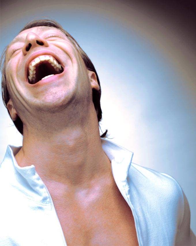 Ottaviano Blitch, Italian actor and performer, expressive theatrical portrait laughing with head back in an open white shirt, attore performer italiano ritratto espressivo teatrale