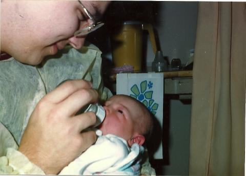 Daddy feeding baby Kevin.