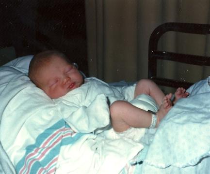 Sleeping soundly on mommy's lap.