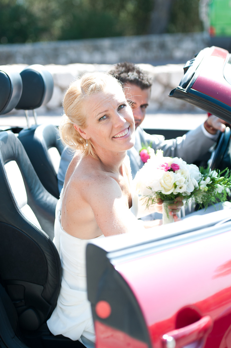 Portrait de la mariée entrant dans sa voiture