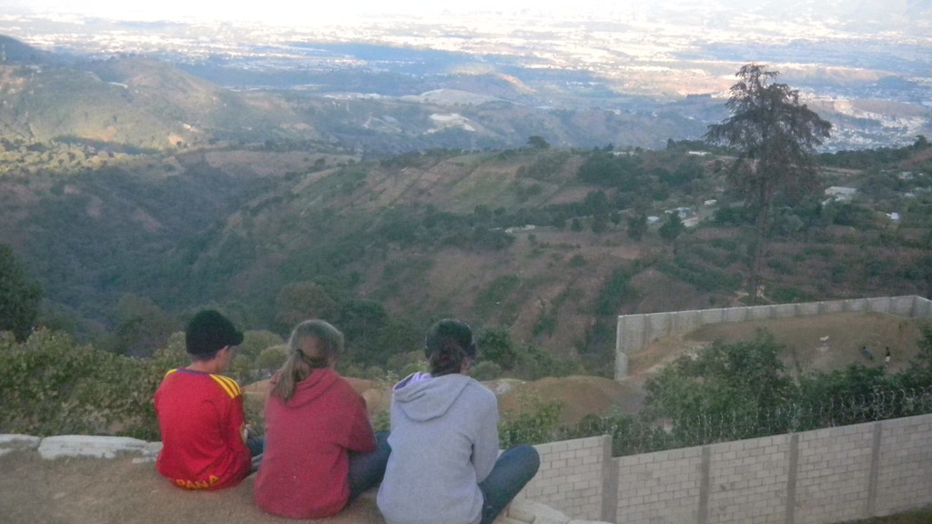 kids looking over the gymnasium retaining wall