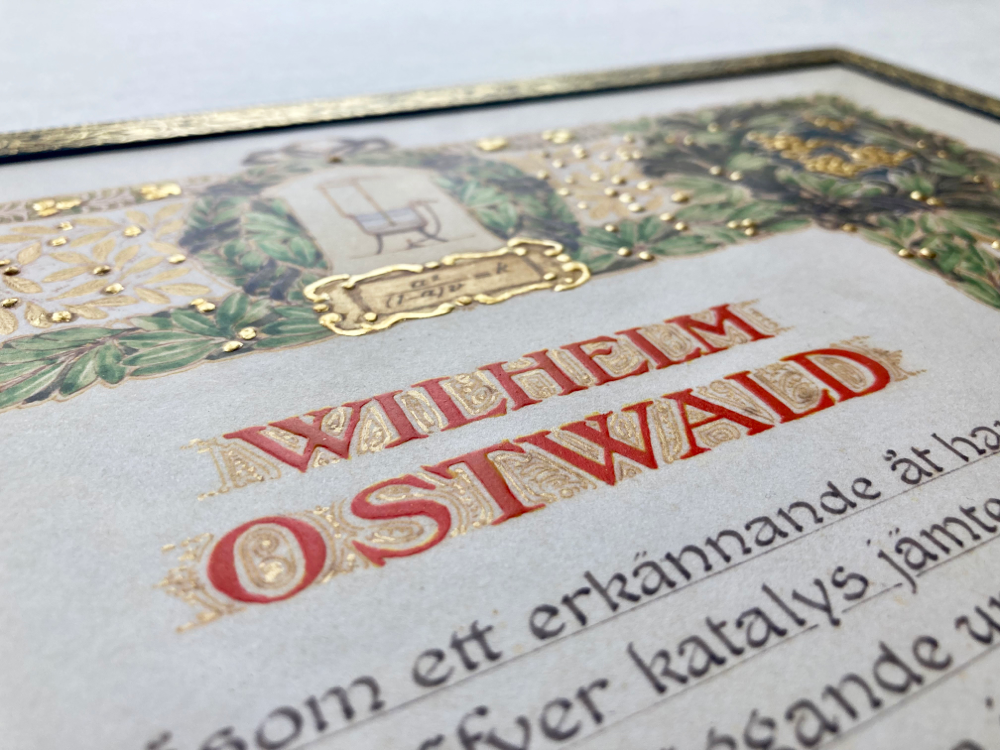 Detail: Lasierte Oberfläche und gehöhter Schrift.