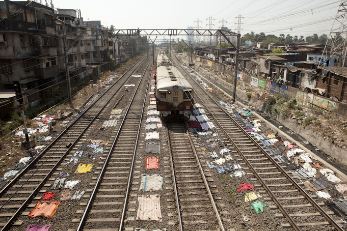 Ashul.Tewari.April22,2014.  Drying clothes aside the railway line that runs between Dharavi.