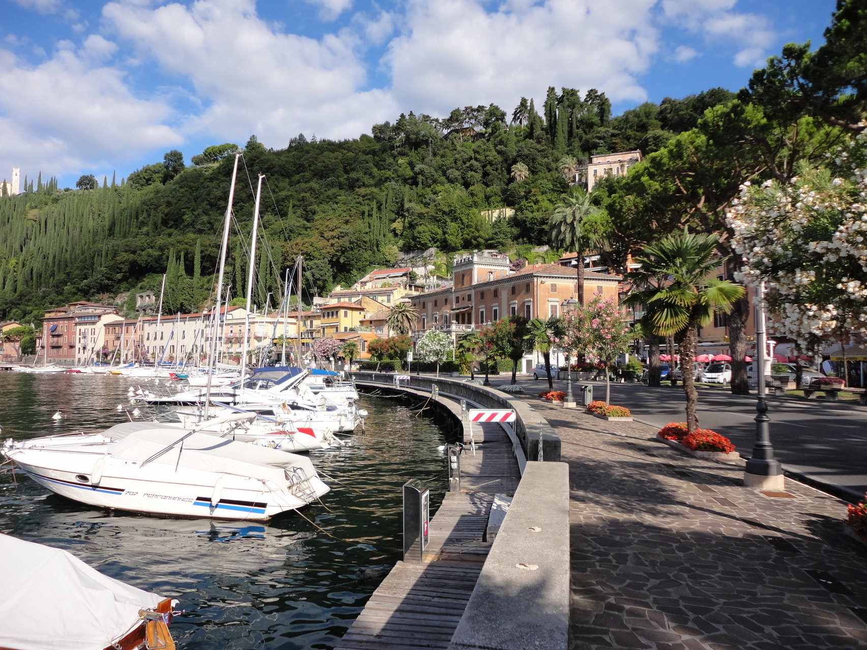 Pretty harbor of Maderno with footpath along the shore