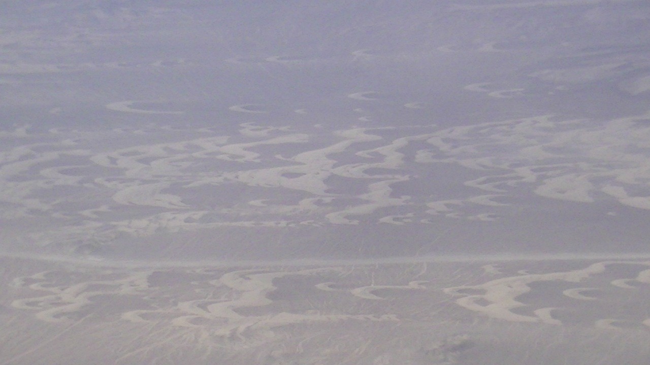ナスカ上空まで砂漠状の平地や丘陵の上を飛行：風で波状の模様ができている