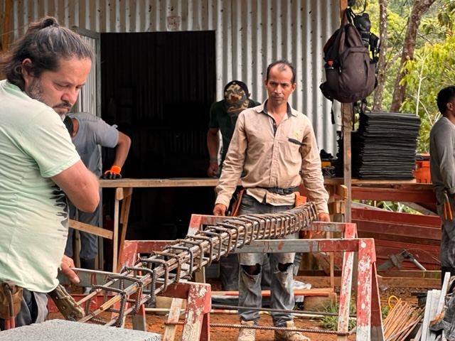 August 2023 - in the foreground, the grounding irons for the pool edge are wired together. In the background the asphalt shingles are cut into thirds