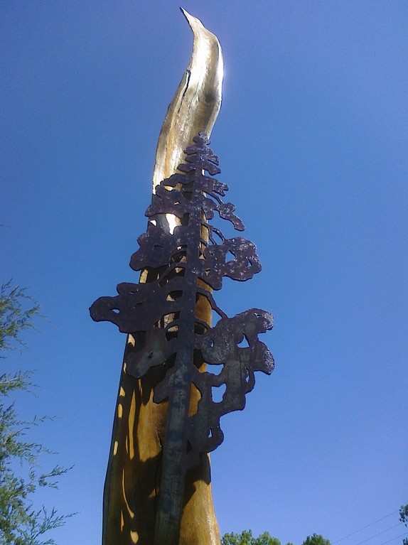 Plasma cut steel tree and white oak spire; part of a larger memorial gathering area