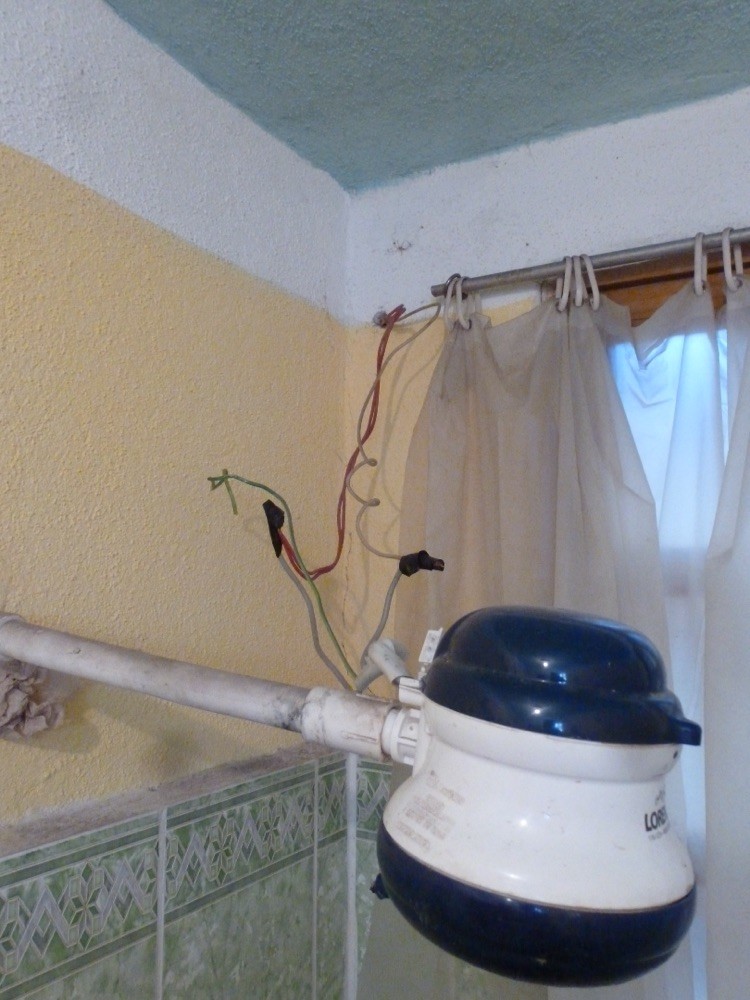 Common Guatemalan shower head in our budget accommodations - This looks safe, right?