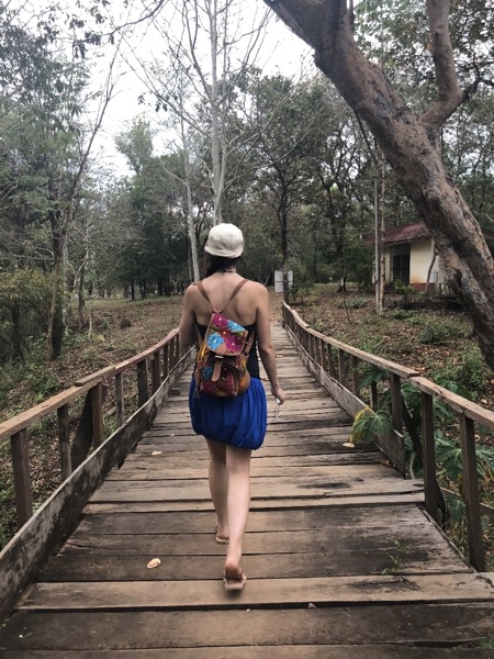 Irene walking on a bridge on a very hot day on Don Khon, Laos