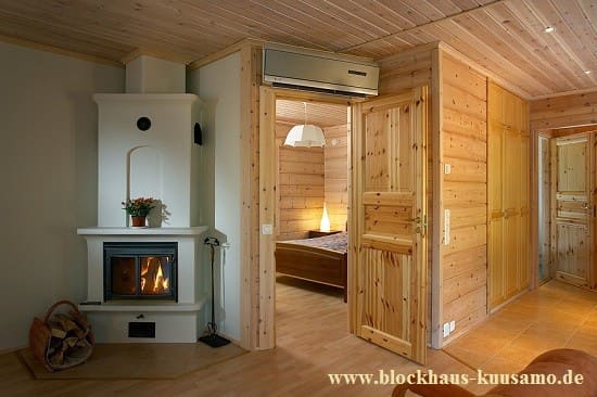 Blockhaus mit Kachelofen im Wohnzimmer - Energiesparhaus - Holzhaus kaufen und bauen