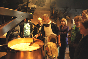 Demo Swiss Cheese making with people standing around