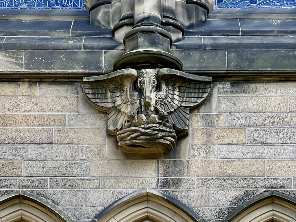 White stork carving on the Memorial Chapel exterior