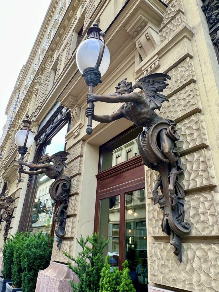Devilish faun statues on the exterior of New York Café