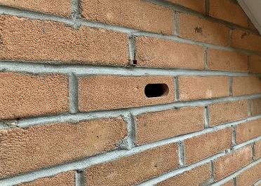photograph of a fitted swift brick below the eaves of a house