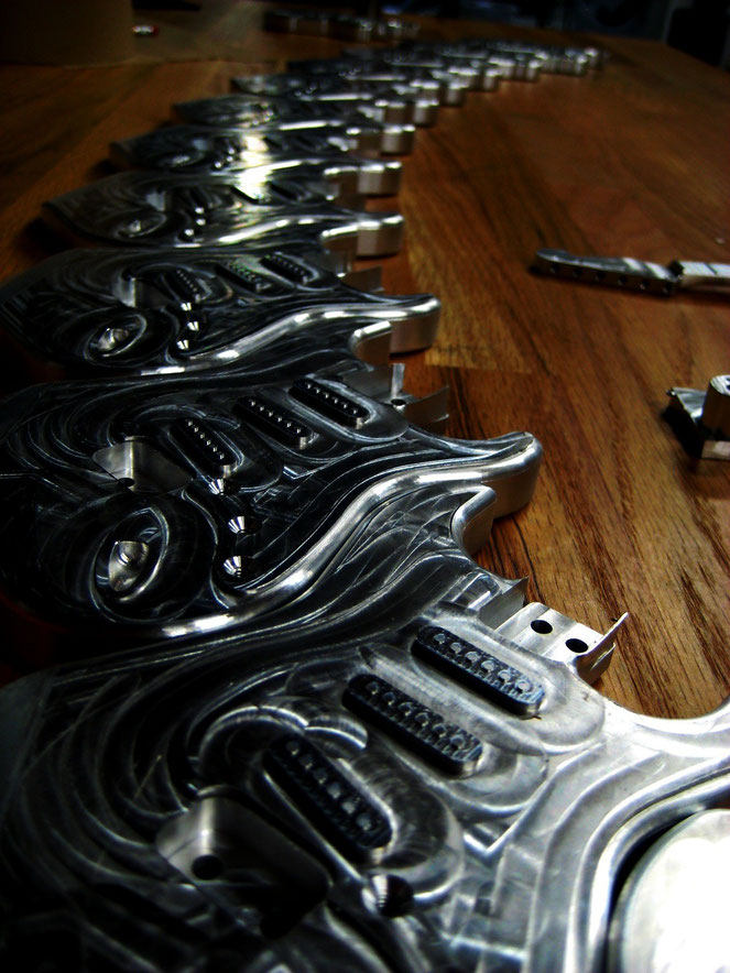 A nice array of small guitars machined from 6061 aluminum Gene Giarratano and I made a bunch of these and had them anodized.