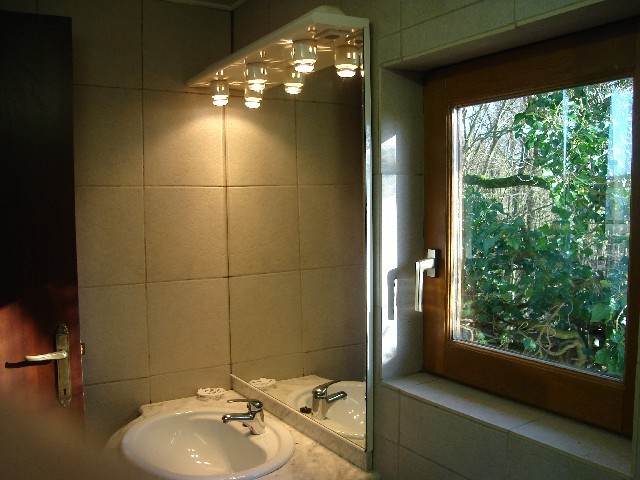 A bathroom with bath - shower, washbasin, WC