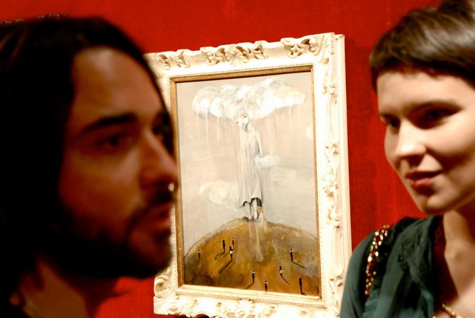 Ixie and Marco Pisanelli with ixie's painting on the background
