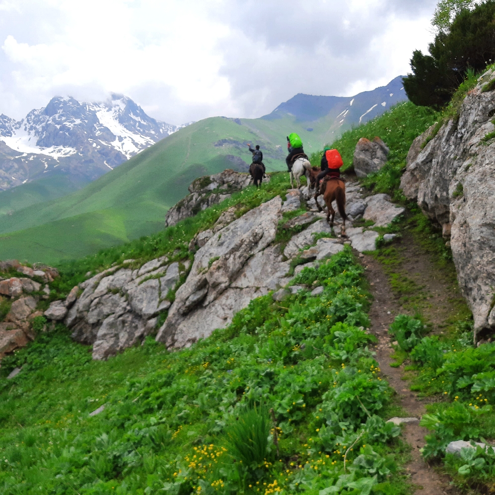 Real horse riding in Southern Kyrgyzstan. Approaching the show covered paths 