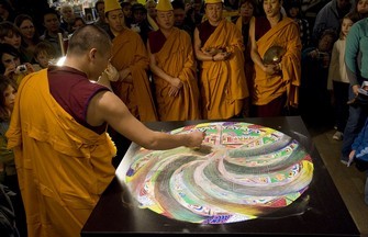 Tibetan monks dismantling a sand mandala