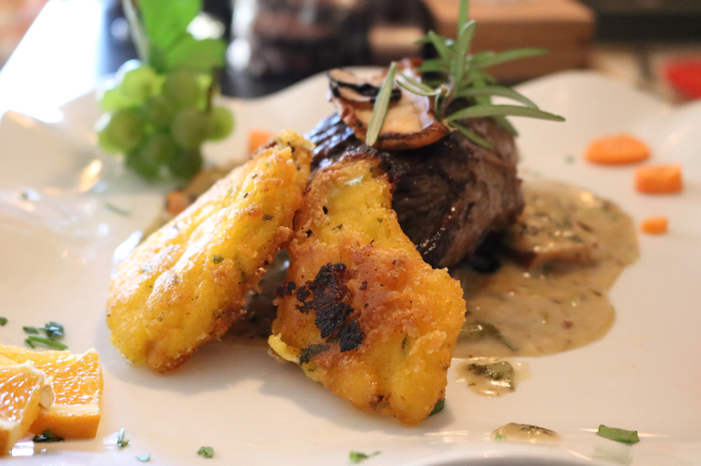 Rinderfilet auf feiner Trüffelcreme mit frischen Steinpilzen an hausgemachter Polenta, mit frischen Trüffelscheiben garniert (Tagesempfehlung)