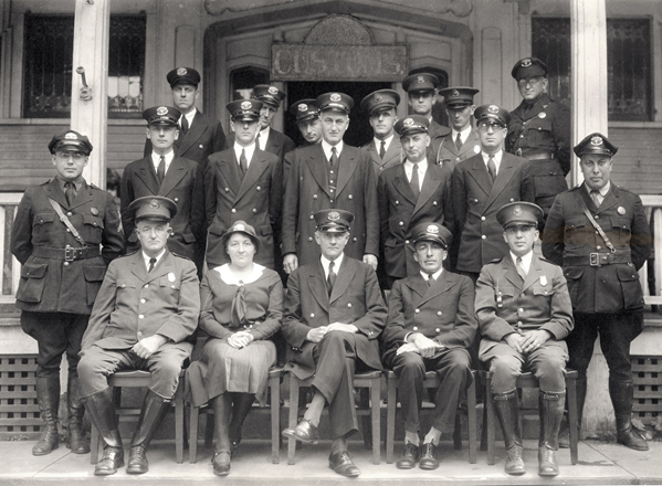 Derby Line, Vermont and Rock Island, Canada Border Crossing - Early 1930s Customs port director, inspectors, inspectress, and patrol inspectors sit for a portrait with the Immigration Service's immigrant inspectors and patrol inspectors on the steps of th