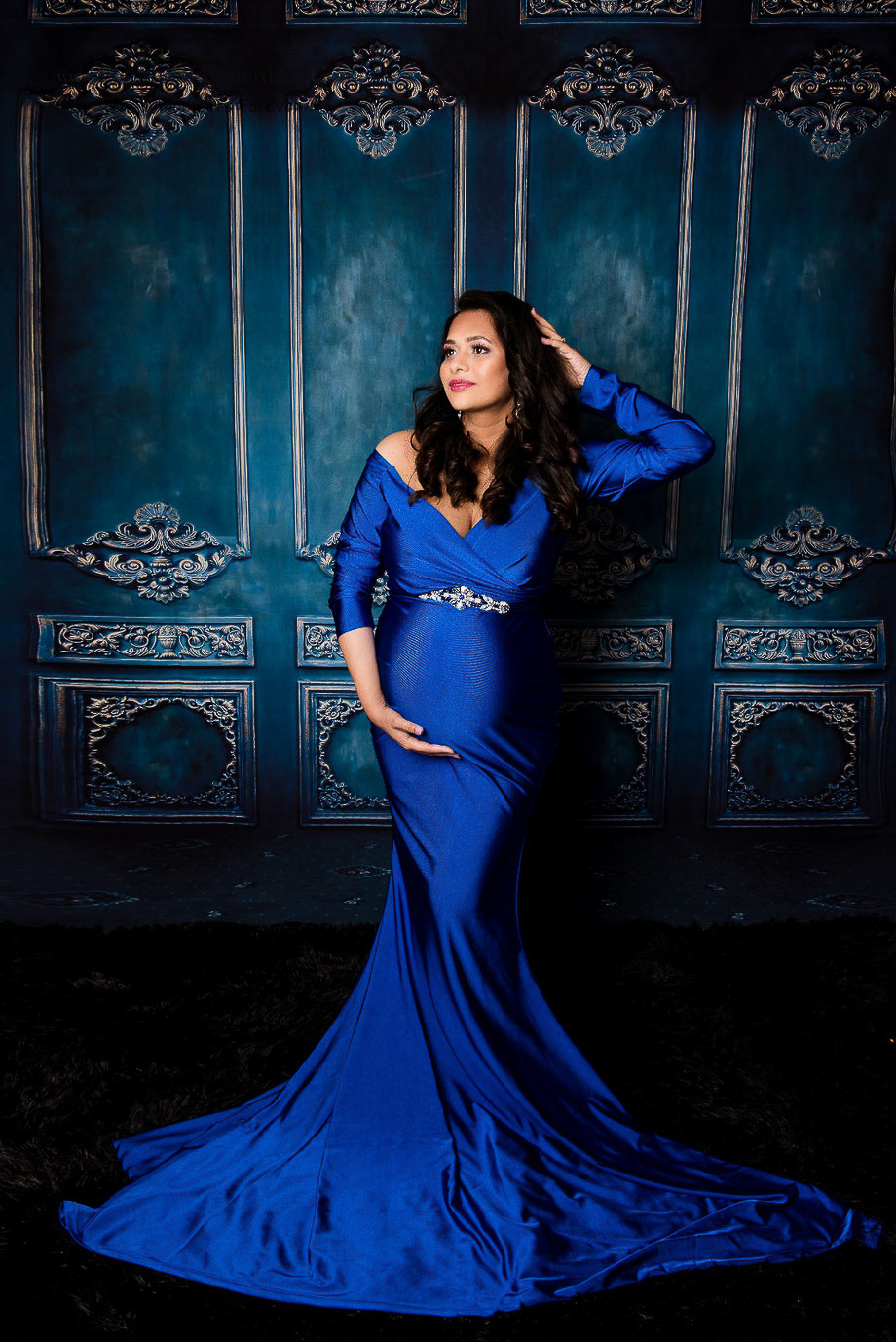 pregnant woman with artisctic blue wall