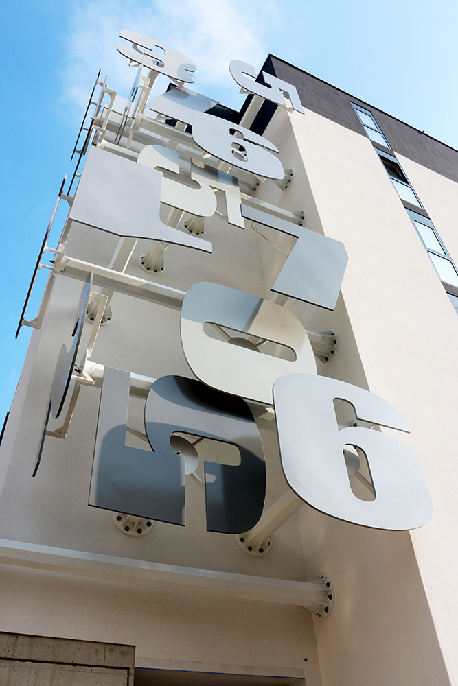 paolo grassi conceptual installation massagno upward detail numeric sculpture suspended facade