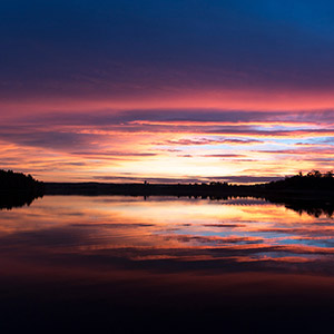 Variations of Red,and Blue, sunset at a lake with reflections close to Hundiksvall, Sweden, Scandinavia