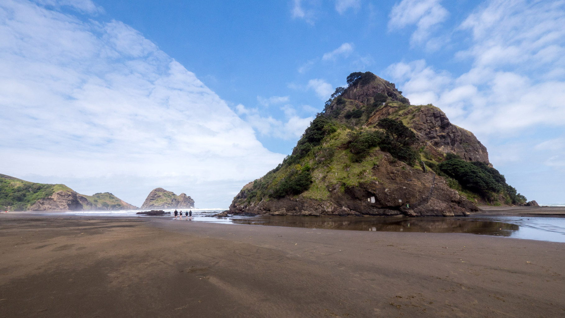 Rough but beutiful West Coast with dark sand beach, just one hour drive from Auckland. Piha beach with Lion rock