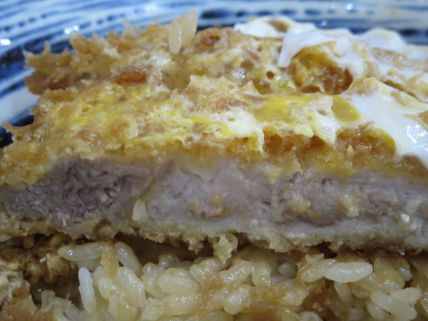 ラーメン龍屋のジャンボカツ丼のとんかつの断面の近影画像。