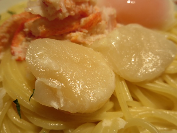 洋麺屋 五右衛門の紅ズワイガニと帆立のクリームソース 温泉卵添えの帆立の近影画像。